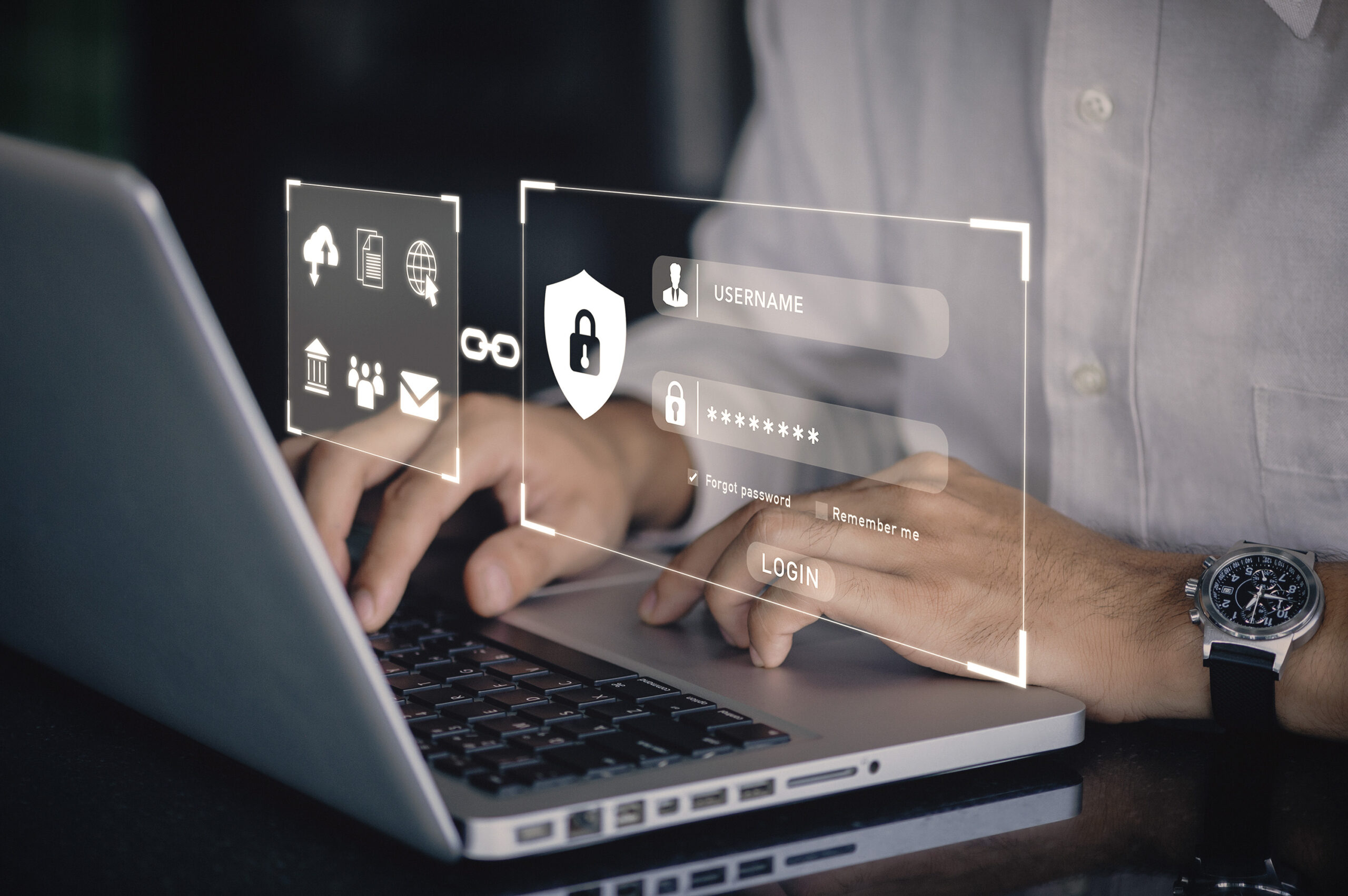 user typing login and password on silver laptop