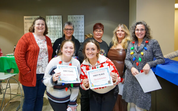 Administrative team members at Ellin & Tucker pose with their first place decorating contest certificates